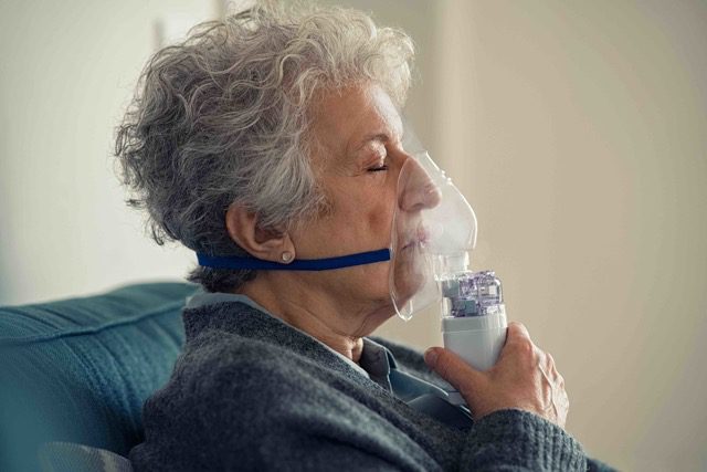 Pulmonary Services. Woman with nebulizer.